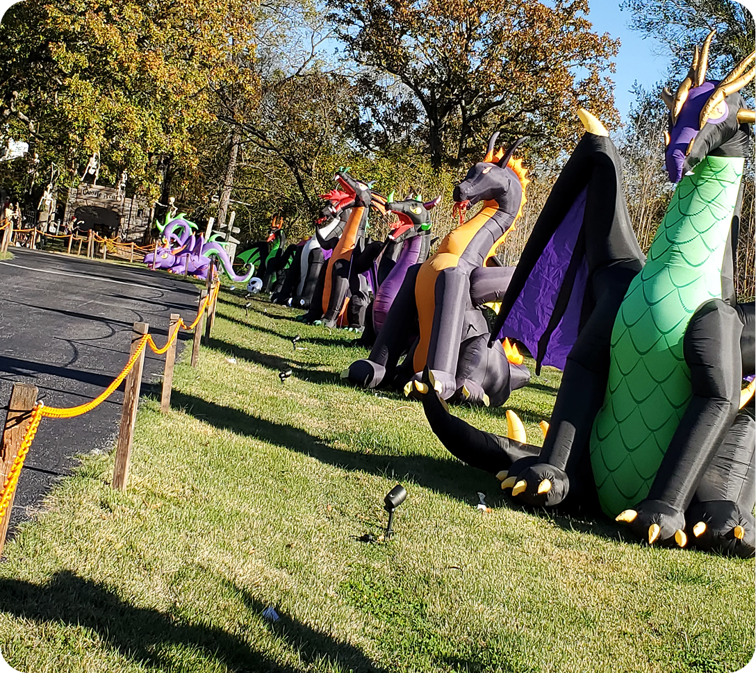 Inflatable dragon decorations lined up outdoors.